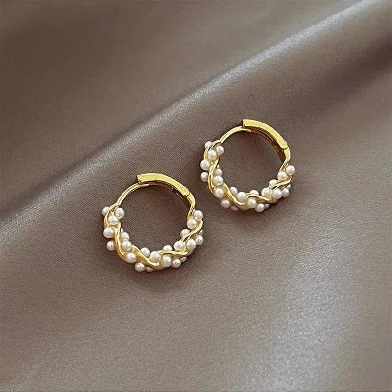 Elevate your style with the timeless sophistication of our Circle Pearl Earrings. These exquisite earrings feature lustrous pearls set in a chic circular design, blending classic elegance with modern flair. The smooth, iridescent pearls are delicately encircled by a sleek, polished metal ring, creating a harmonious balance of opulence and simplicity.