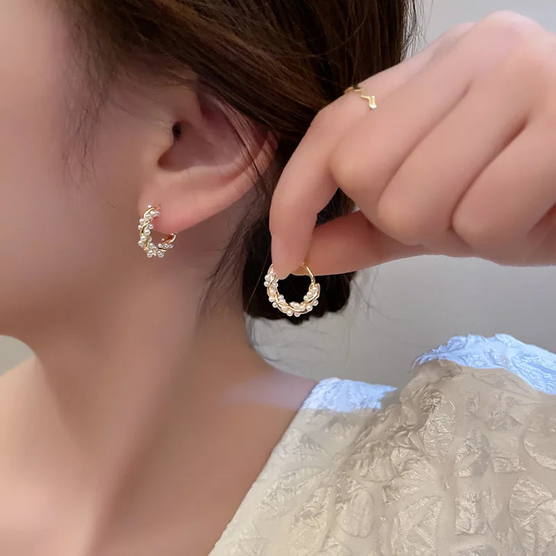 Elevate your style with the timeless sophistication of our Circle Pearl Earrings. These exquisite earrings feature lustrous pearls set in a chic circular design, blending classic elegance with modern flair. The smooth, iridescent pearls are delicately encircled by a sleek, polished metal ring, creating a harmonious balance of opulence and simplicity.