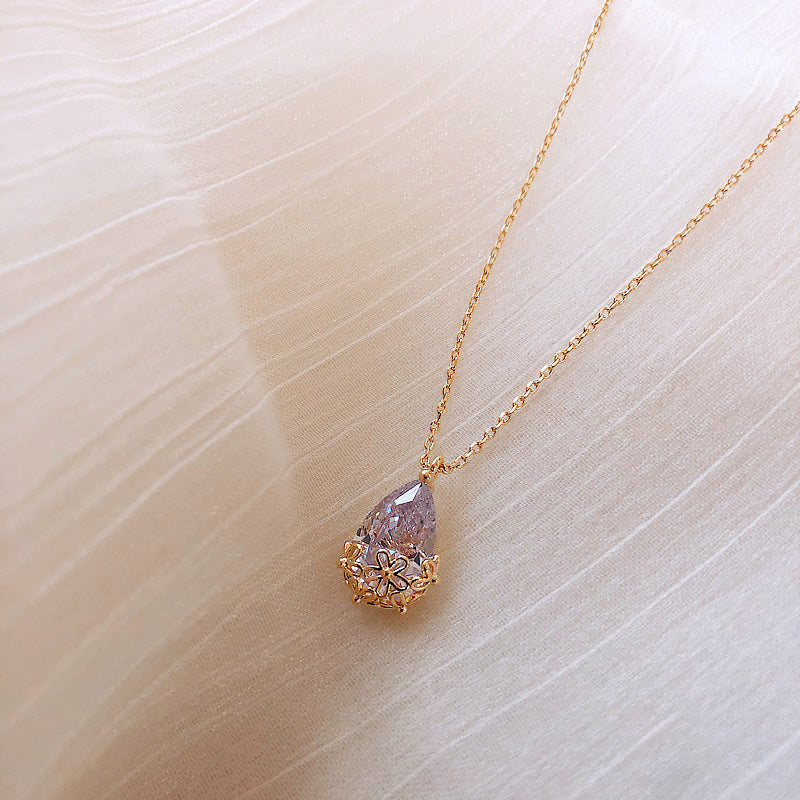 Enhance your look with the timeless elegance of our Crystal Water Drop Pendant Necklace. This stunning piece features a beautifully cut crystal in a water drop shape, catching the light with every movement and adding a touch of sophisticated sparkle to any outfit.